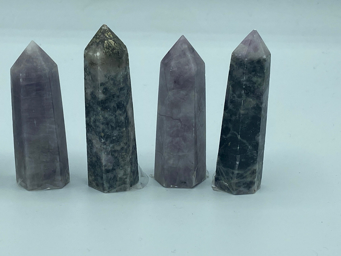 Kunzite towers with tourmaline and pyrite inclusions. Pick your favourite crystals. Metaphysical, love, romance, stone