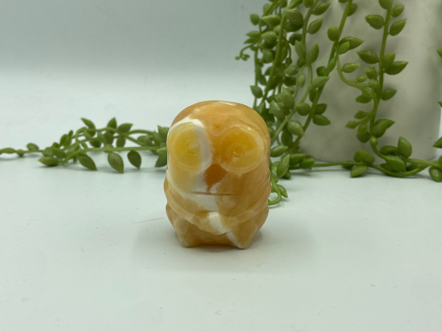 Orange/honey calcite banded minion figure. Yellow calcite, bello!