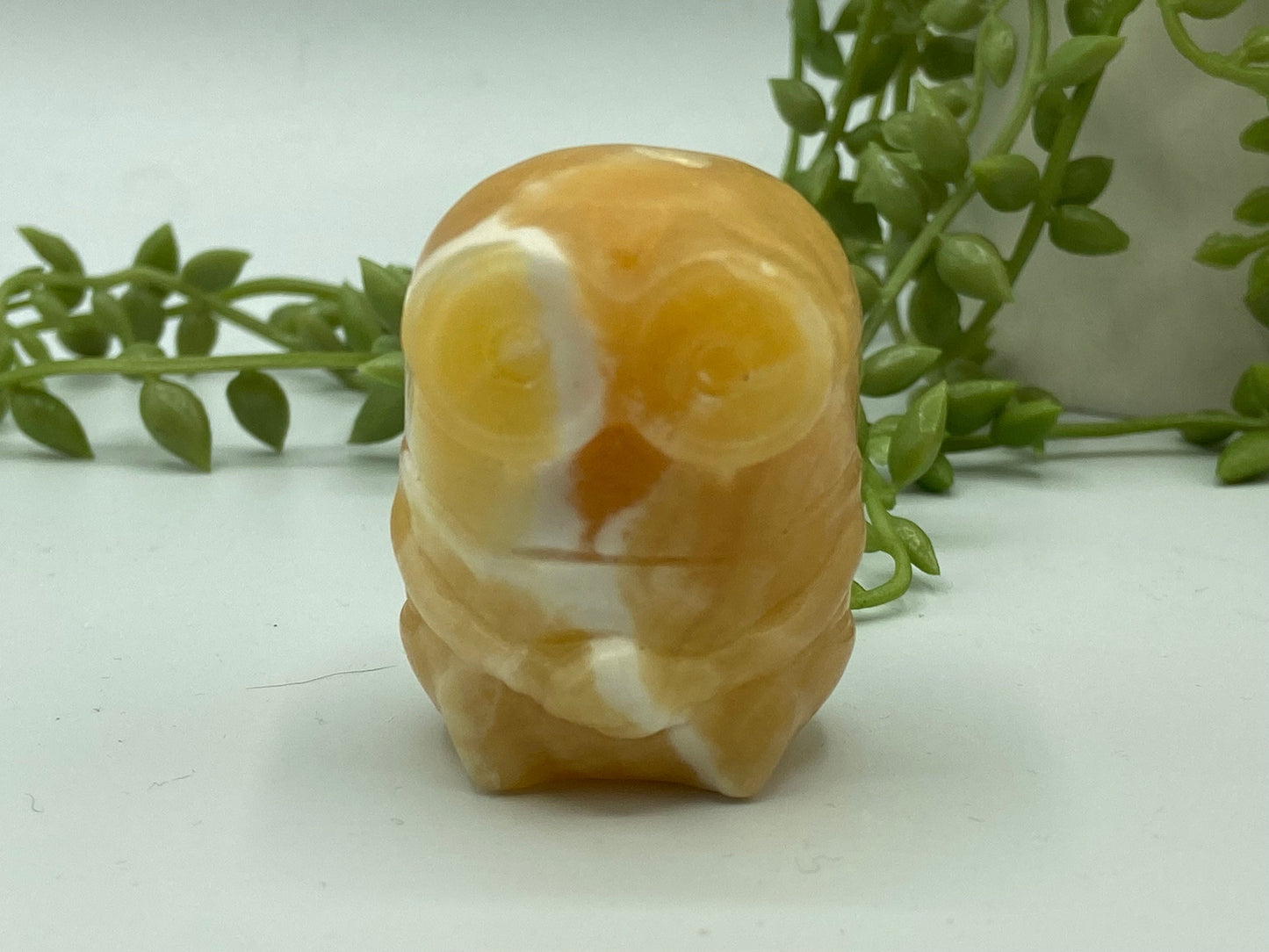 Orange/honey calcite banded minion figure. Yellow calcite, bello!