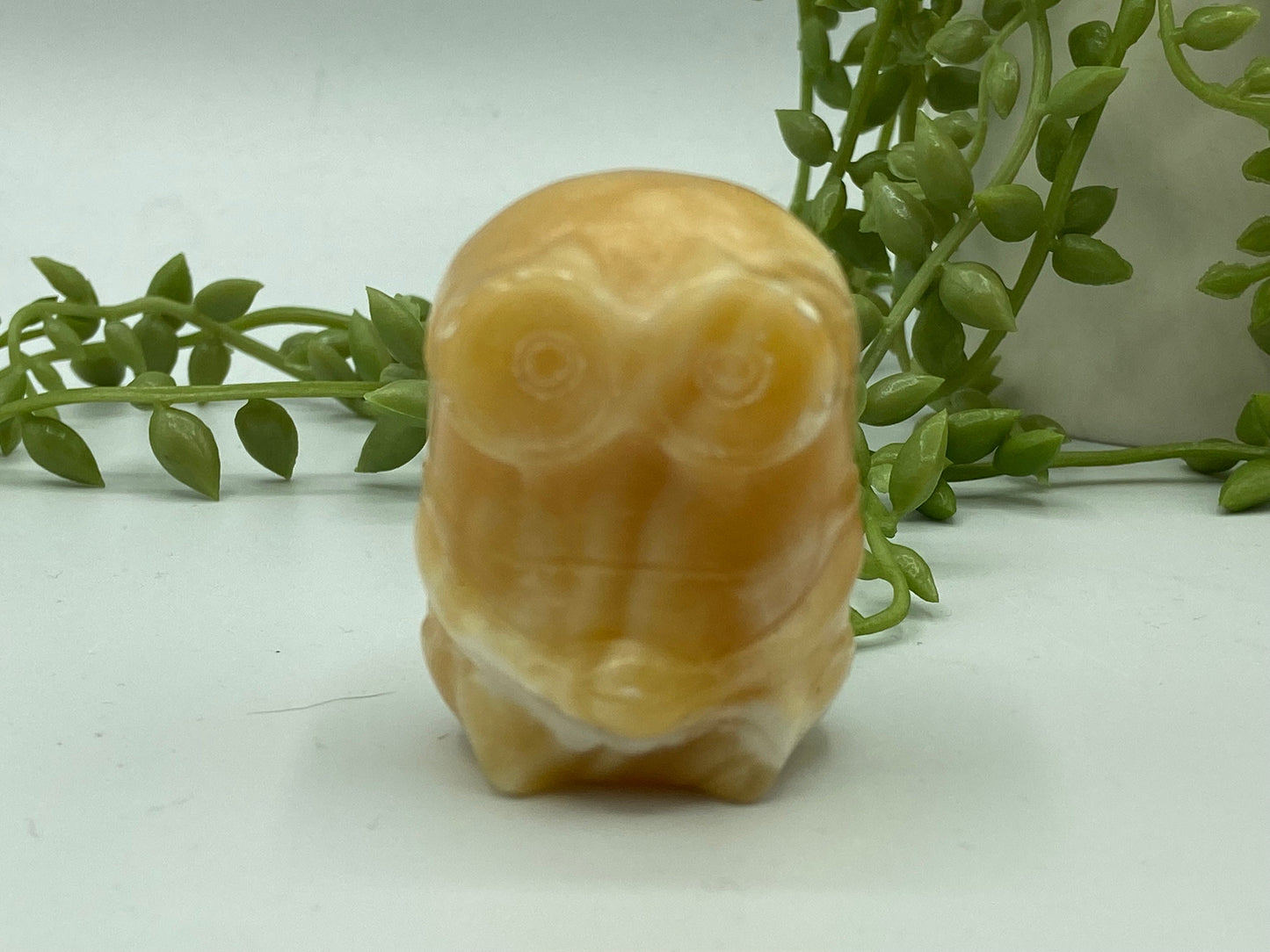 Orange/honey calcite banded minion figure. Yellow calcite, bello!