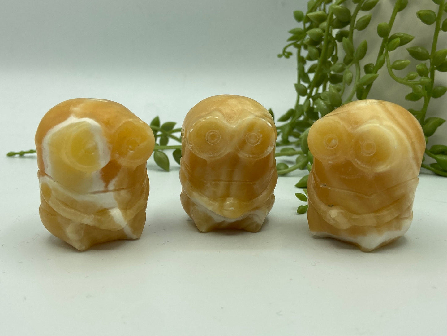 Orange/honey calcite banded minion figure. Yellow calcite, bello!