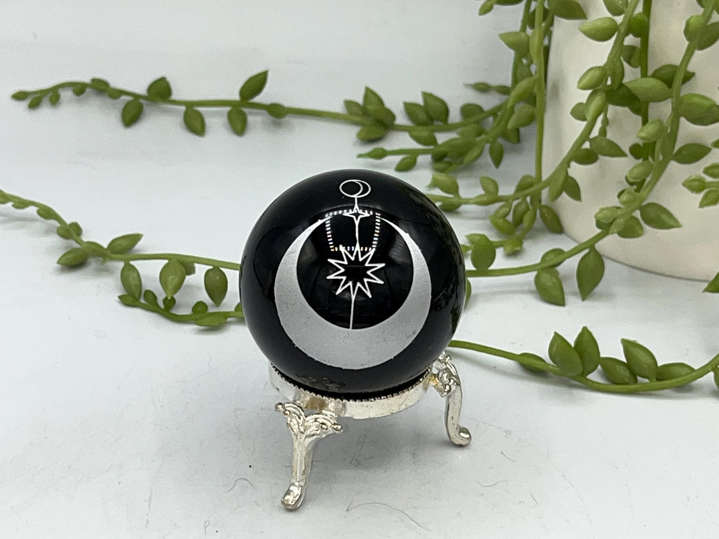 Black obsidian sphere with a moon and star celestial style pattern engraved in silver. crystal spheres, home decor, crystal healing, gift