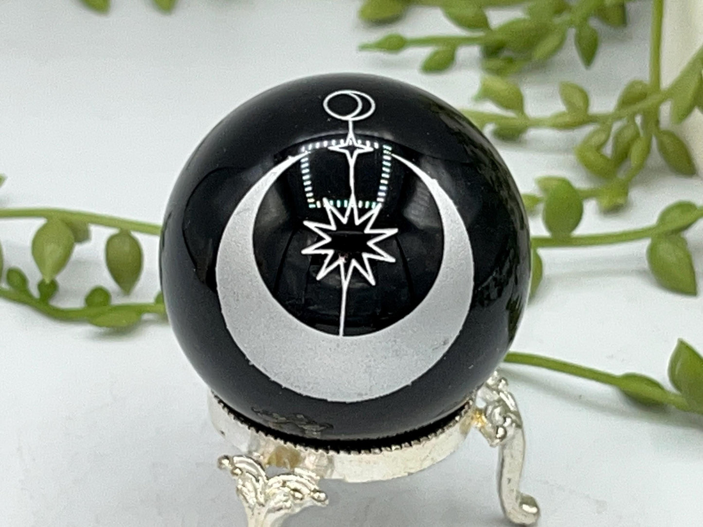 Black obsidian sphere with a moon and star celestial style pattern engraved in silver. crystal spheres, home decor, crystal healing, gift