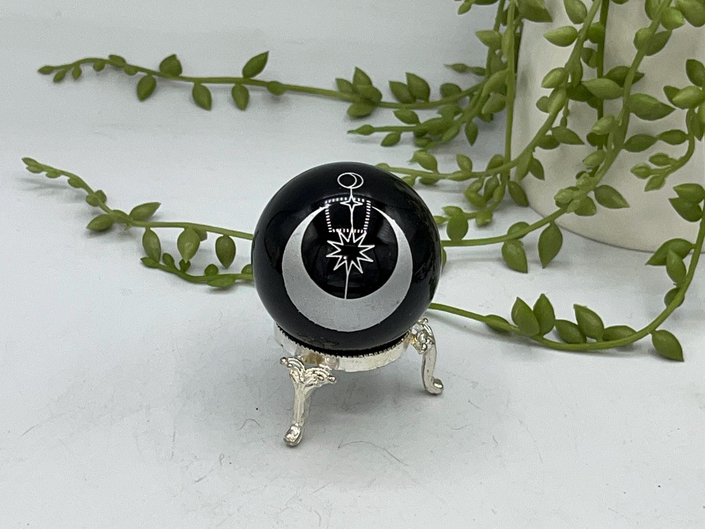 Black obsidian sphere with a moon and star celestial style pattern engraved in silver. crystal spheres, home decor, crystal healing, gift