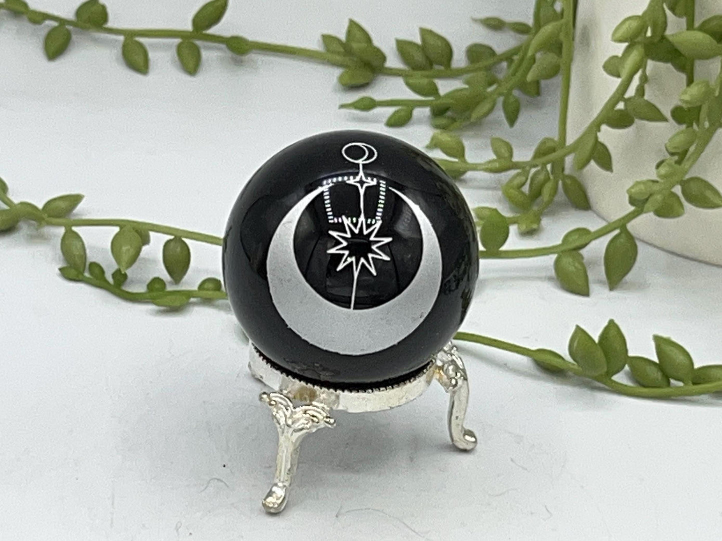Black obsidian sphere with a moon and star celestial style pattern engraved in silver. crystal spheres, home decor, crystal healing, gift