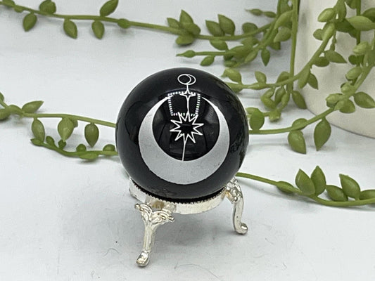 Black obsidian sphere with a moon and star celestial style pattern engraved in silver. crystal spheres, home decor, crystal healing, gift
