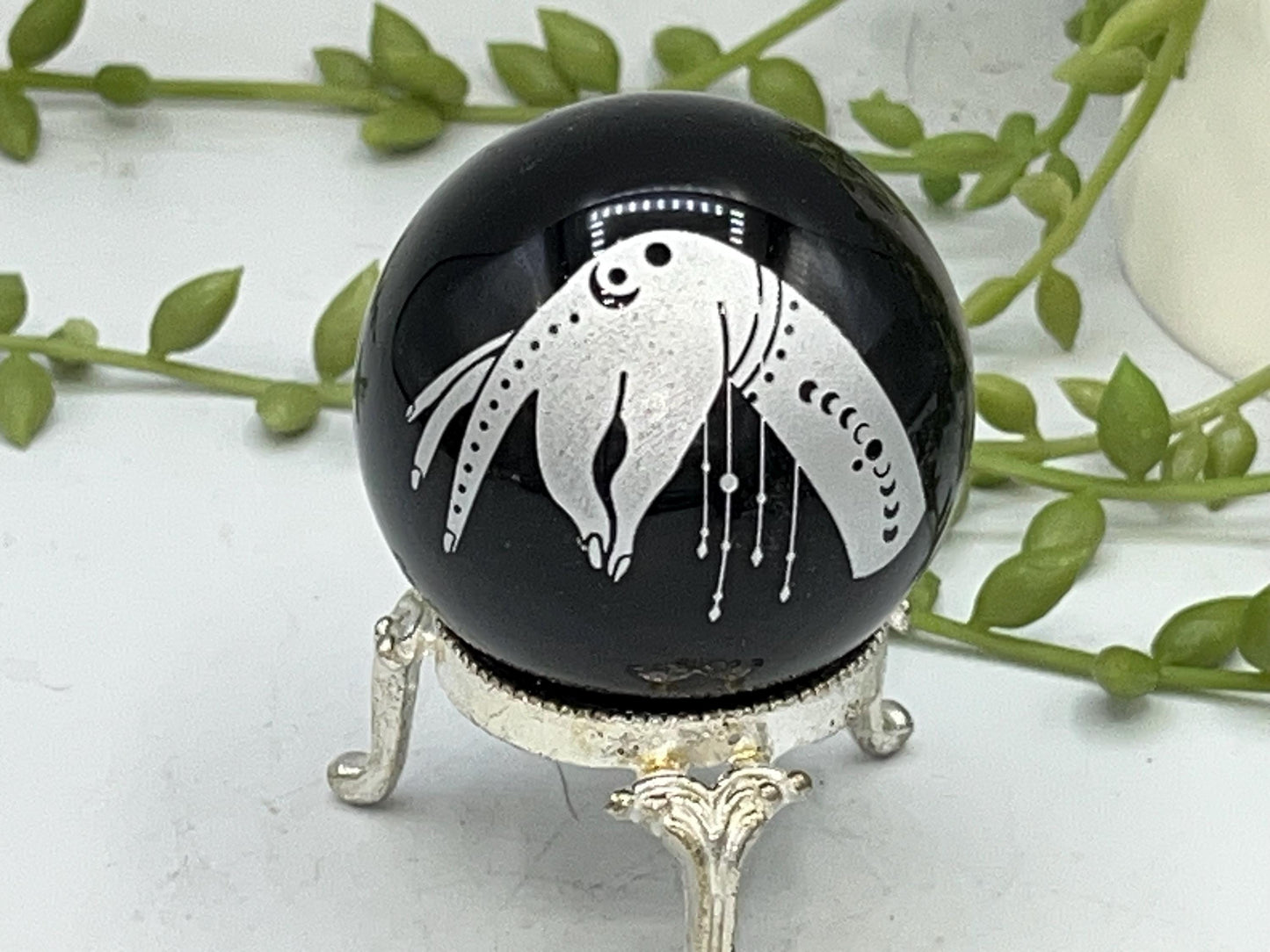 Black obsidian sphere with a beautiful mystical celestial hand pattern with moon phase engraved in silver. crystal spheres, home decor gift