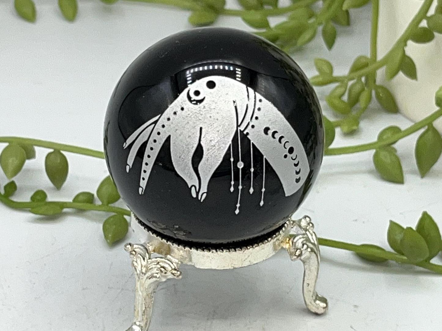 Black obsidian sphere with a beautiful mystical celestial hand pattern with moon phase engraved in silver. crystal spheres, home decor gift