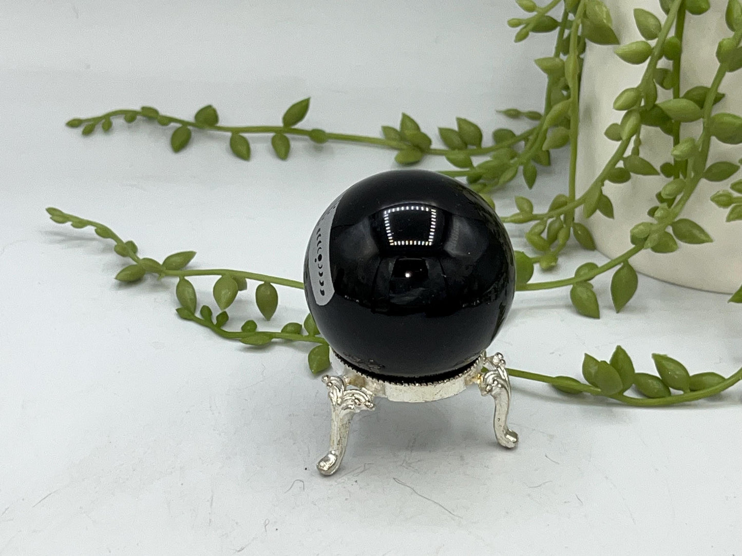 Black obsidian sphere with a beautiful mystical celestial hand pattern with moon phase engraved in silver. crystal spheres, home decor gift